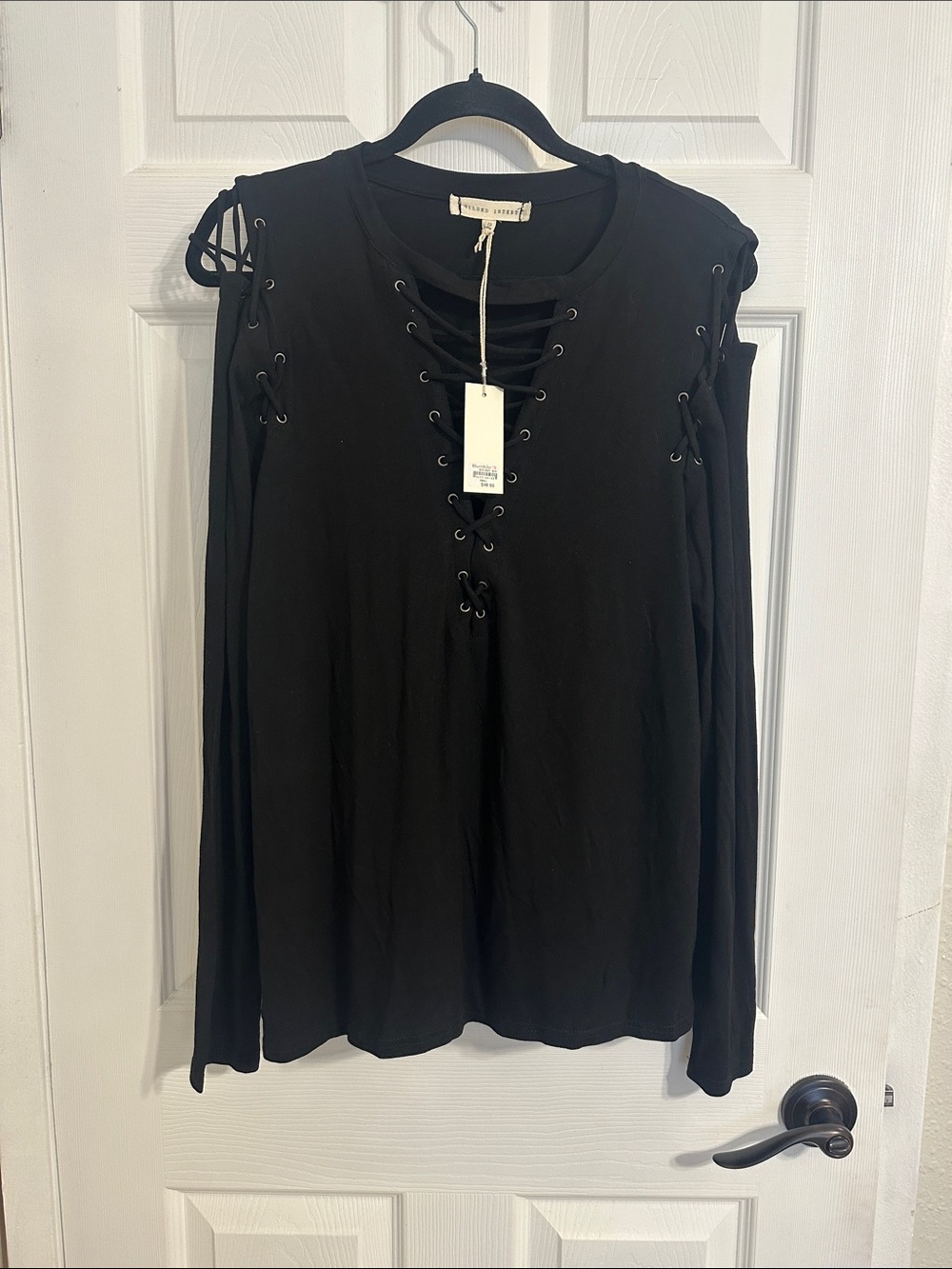Gilded Intent black tunic blouse features a distinct lace-up V-neckline. NWT